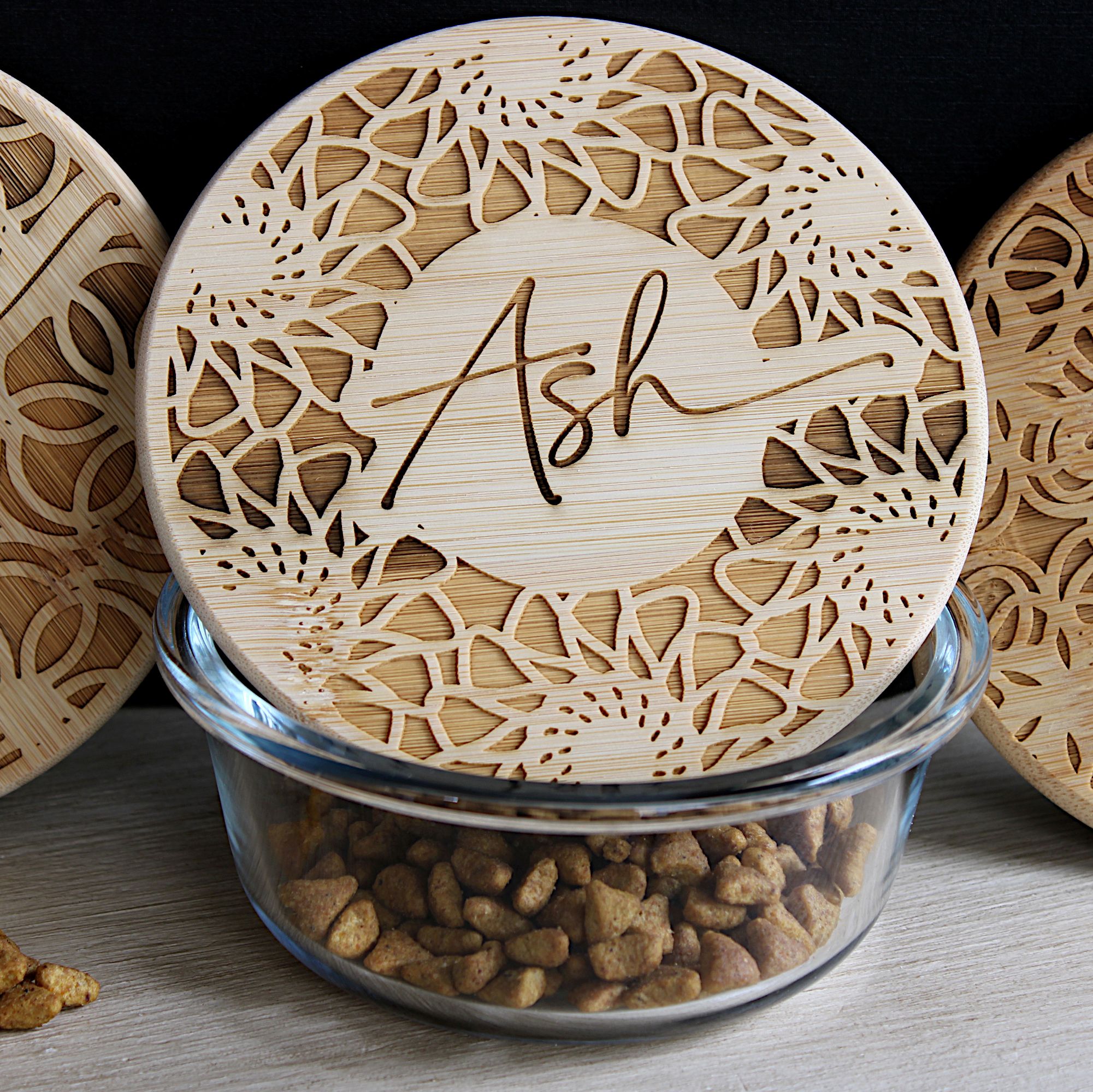 Image of a glass cat food dish with a personalized bamboo lid.